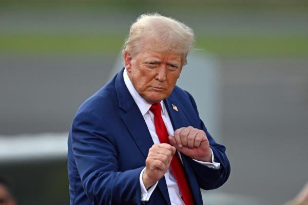 Former US President Donald Trump gesturing at a campaign rally at the North Carolina Aviation Museum & Hall of Fame in Asheboro, North Carolina, August 21, 2024