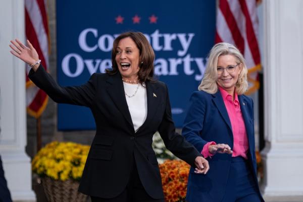 Vice President Kamala Harris and former US representative Liz Cheney walking on stage at a rally in Ripon College, Wisconsin